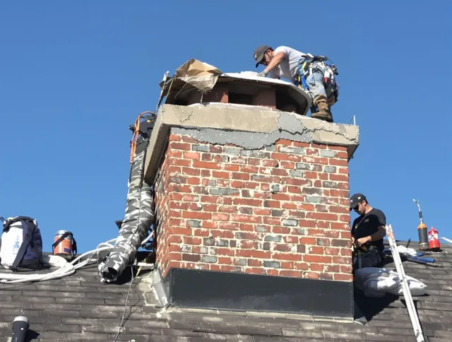 East Hartford Chimney Sweep installing a custom chimney crown in East Hartford, CT